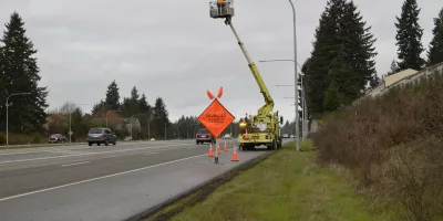 A Photo Of An Outdoor Led Streetlight Being Inspected For Damage